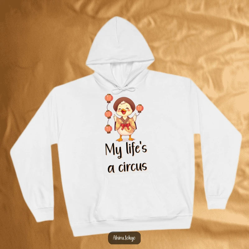 Funny Juggling Duck Hoodie: A cheerful duck in a colorful kimono juggles glowing lanterns, offering cozy warmth and humorous delight.